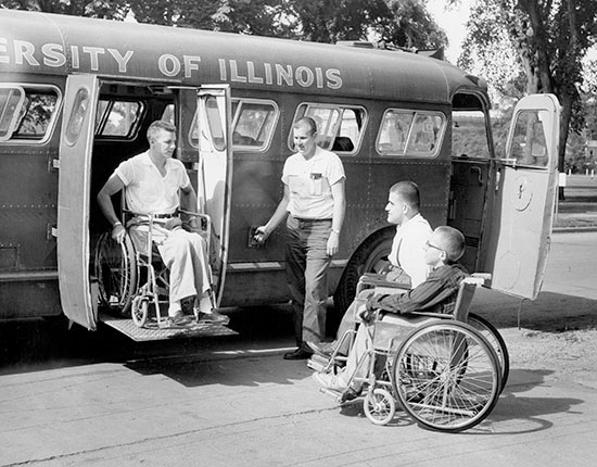 student using wheelchair lift to exit a bus, 1955